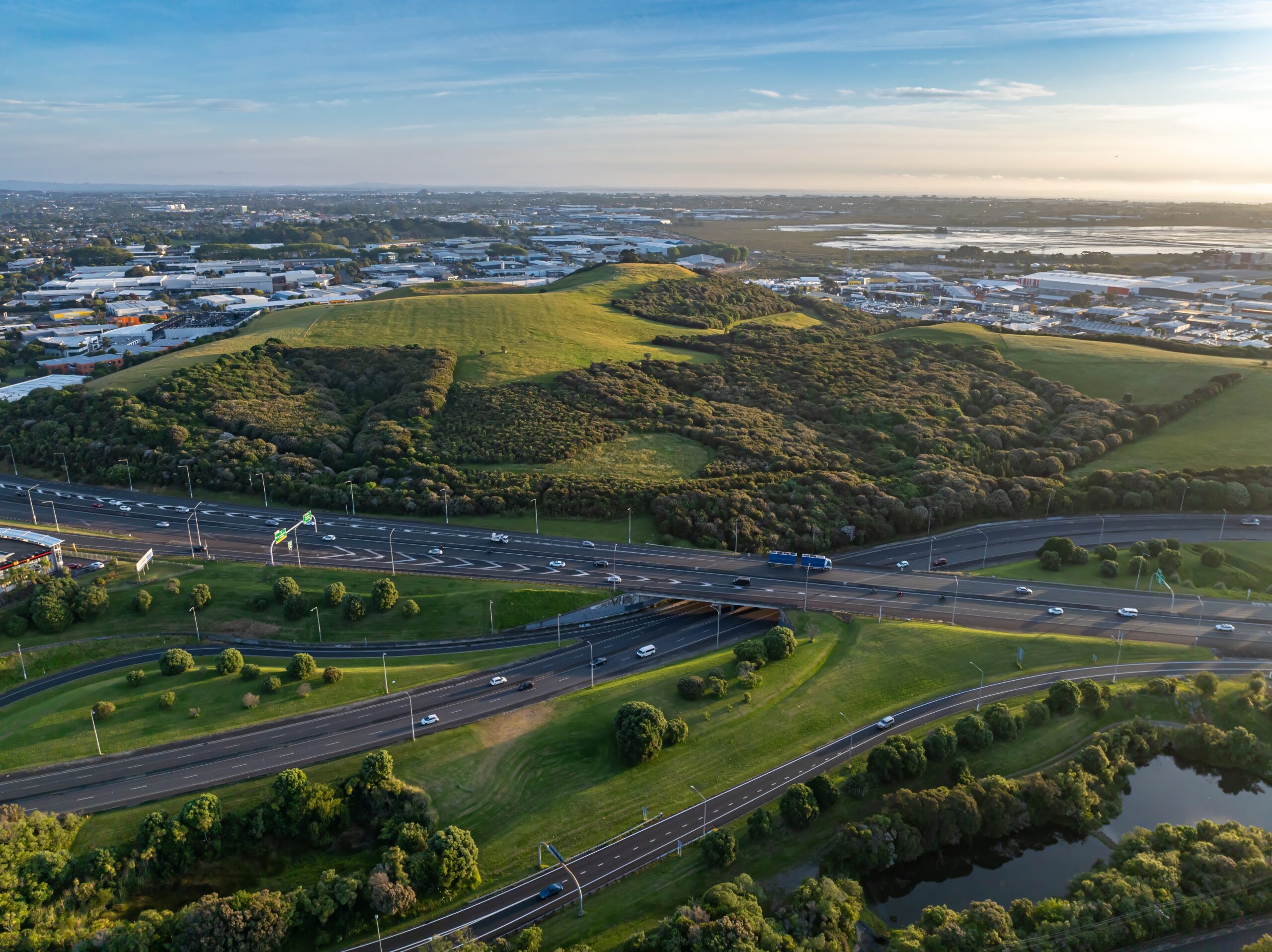 Aerial view of a motorway with industrial buildings in the background