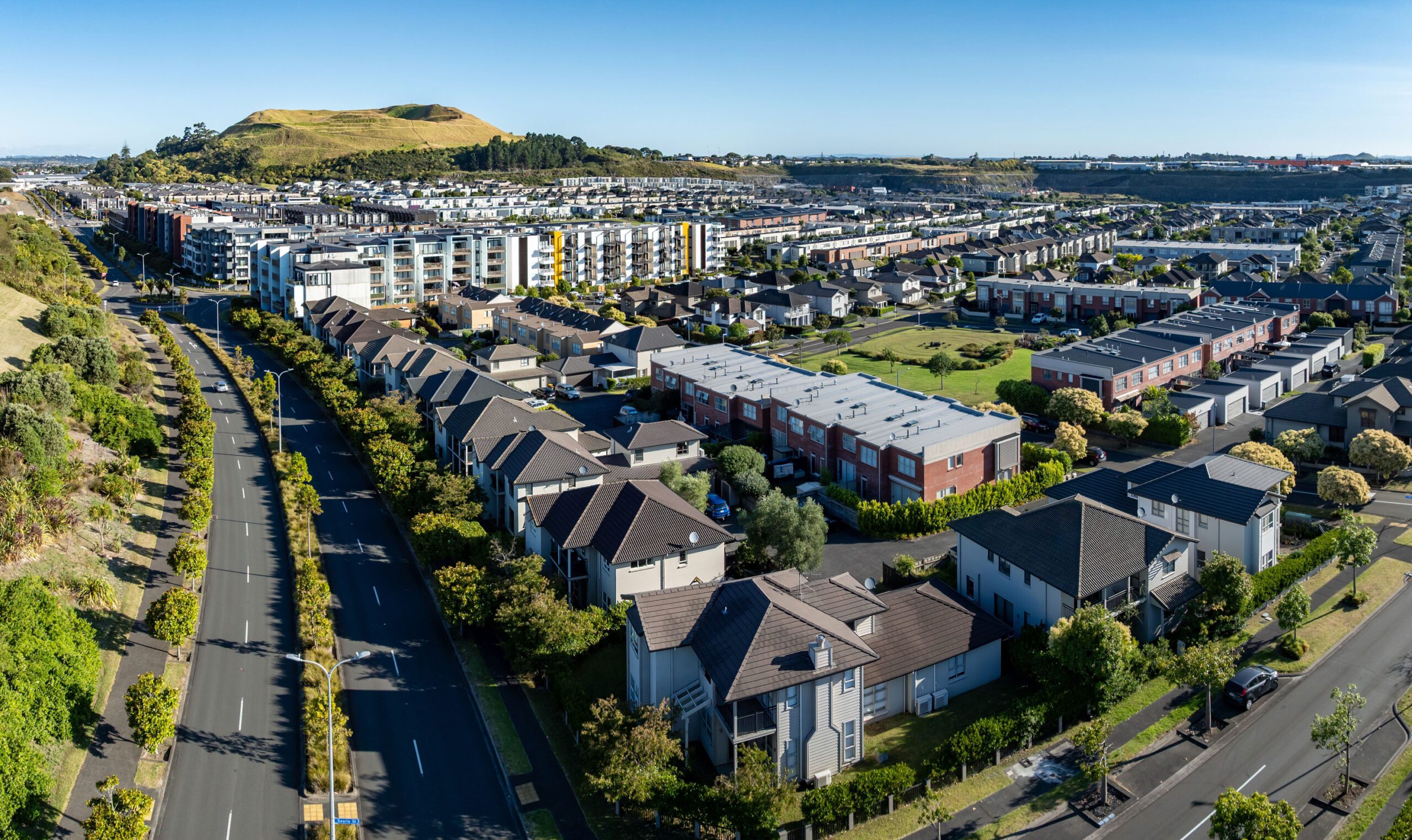 Aerial view of a residential neighborhood with modern apartment buildings and houses.