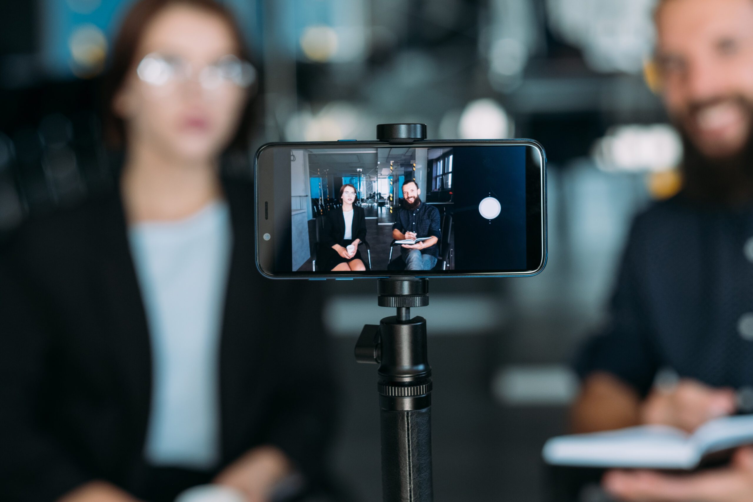 Photo of an iphone setup on a tripod recording a Excellence award video entry