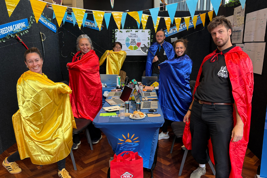 Team members participating in the Management Challenge dressed up in super hero outfits